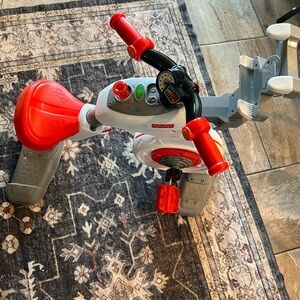 Fisher-Price Red and Gray Ride-On “peloton” bike - has been discontinued